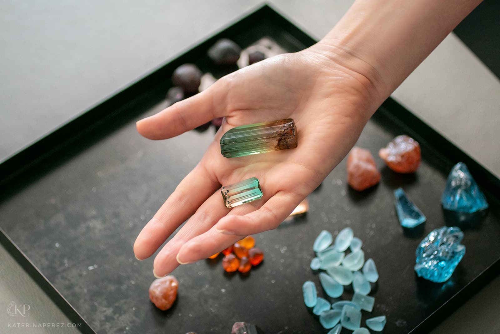 HC Arnoldi bi-colour tourmaline of 25.07 carats alongside a rough tourmaline crystal