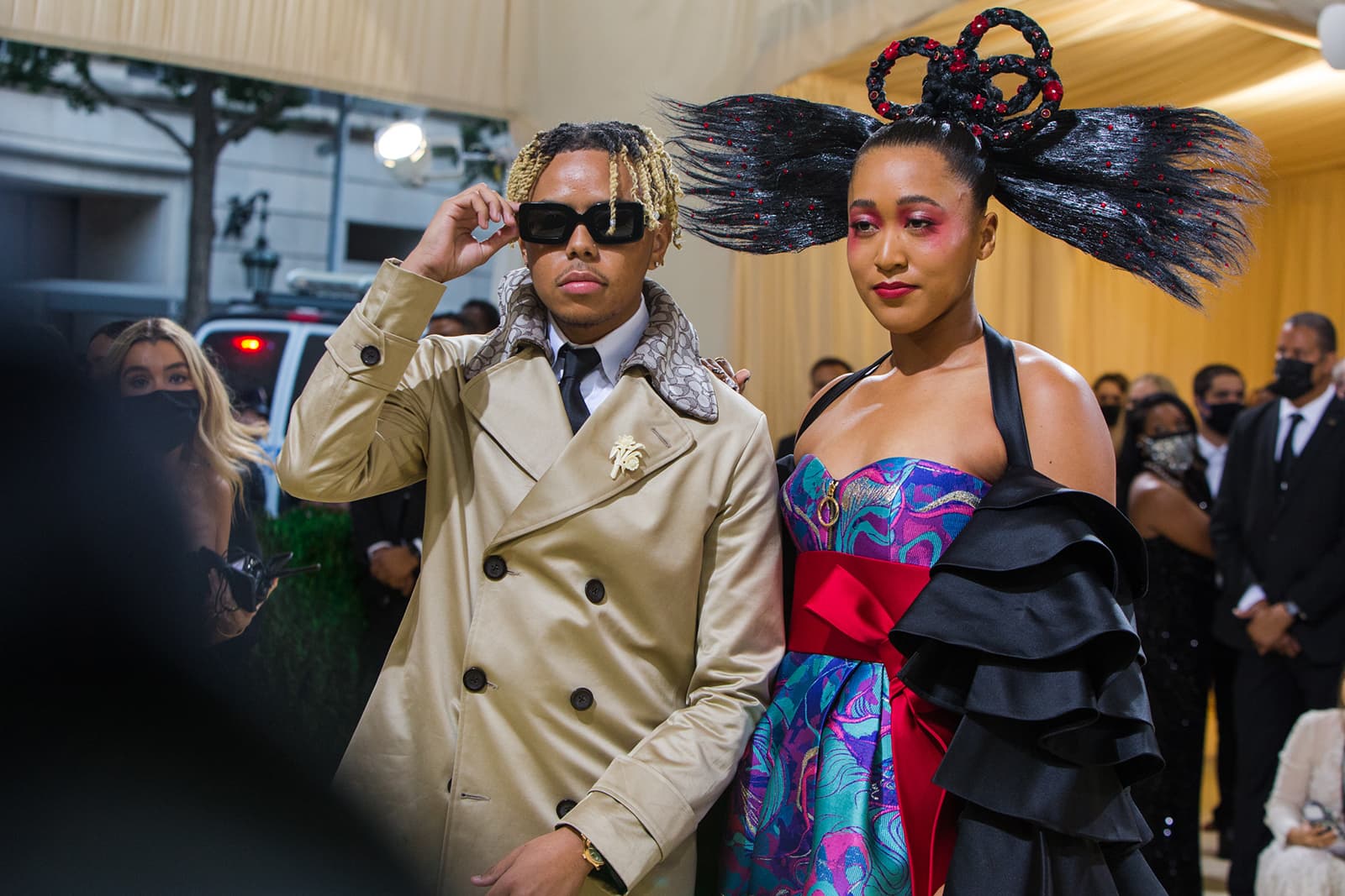 Tennis player Naomi Osaka and her partner, singer Cordae wearing a floral brooch at the Met Gala 2021