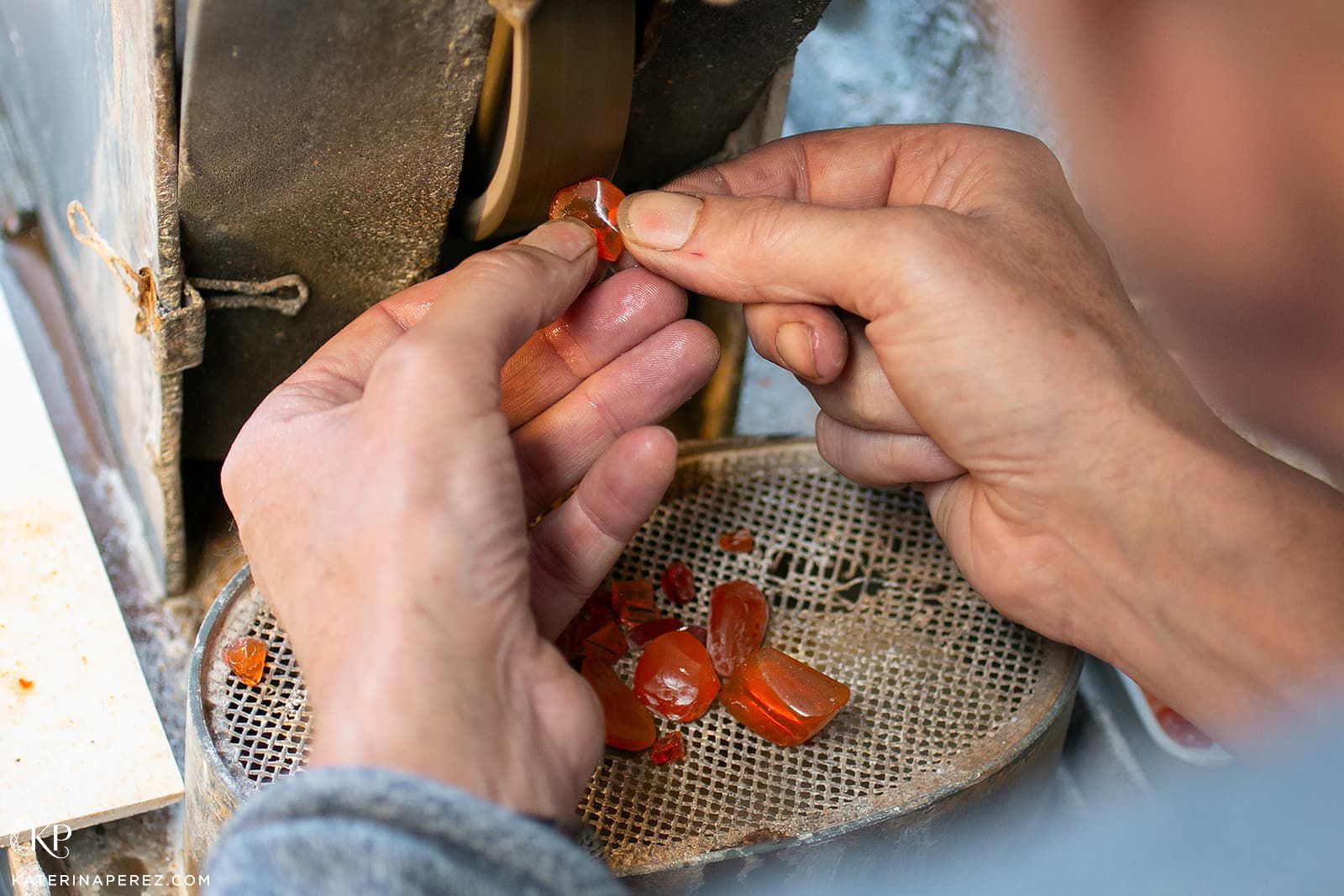 An experienced craftsman at Emil Weis Opals polishes a Mexican fire opal