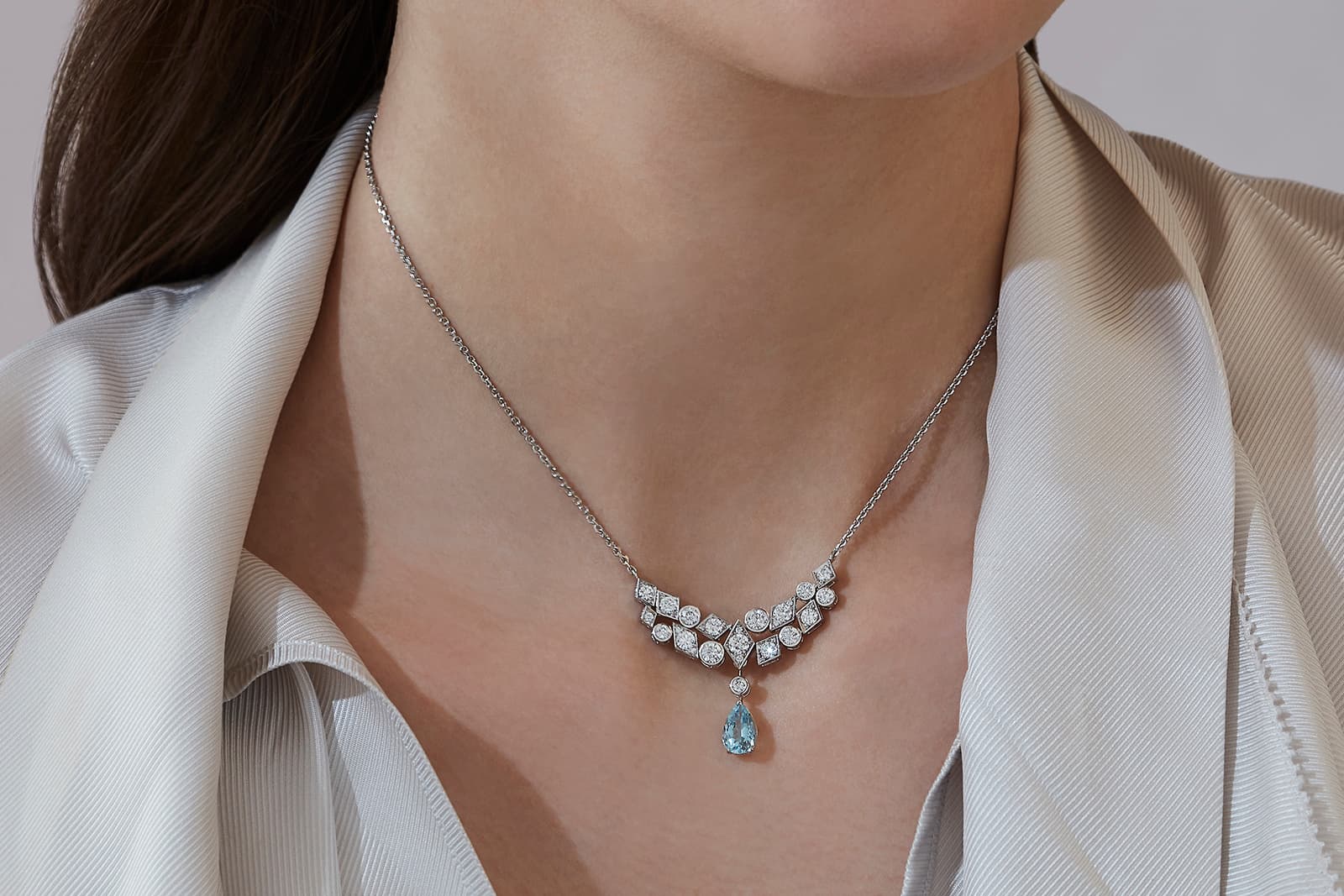  A model wears the Garrard Albemarle diamond necklace with its detachable aquamarine drop, set in 18k white gold 