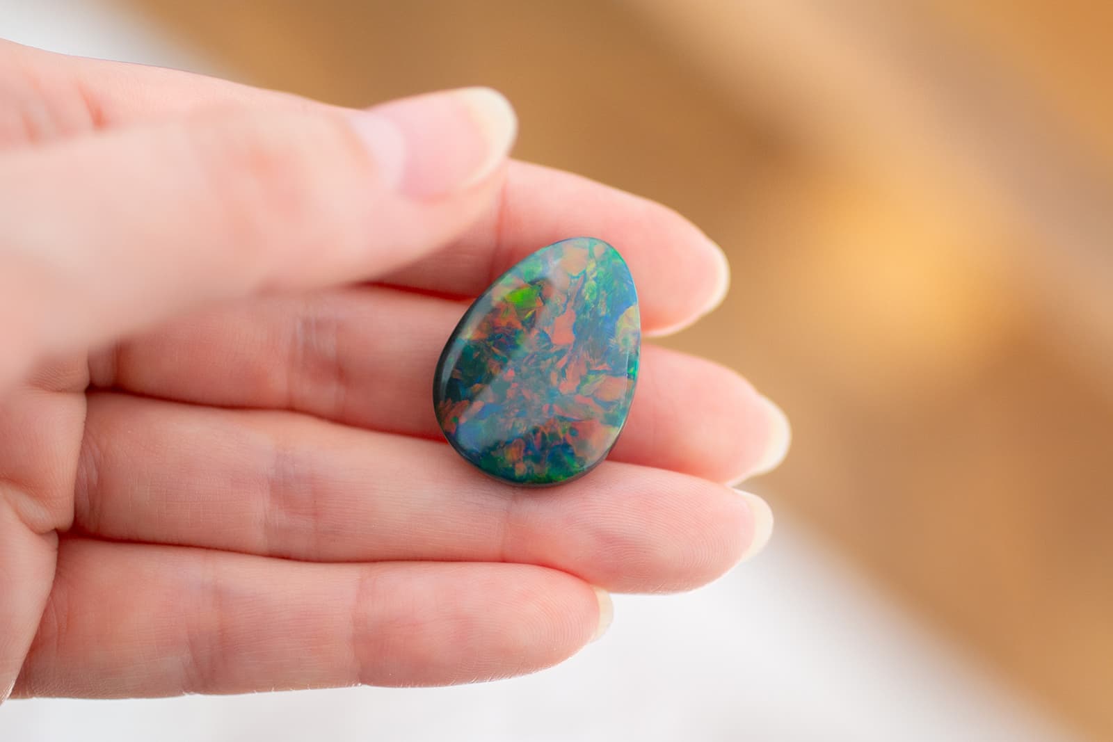  An Australian black opal with red, orange, deep blue and green play of colour, courtesy of IMAGEM