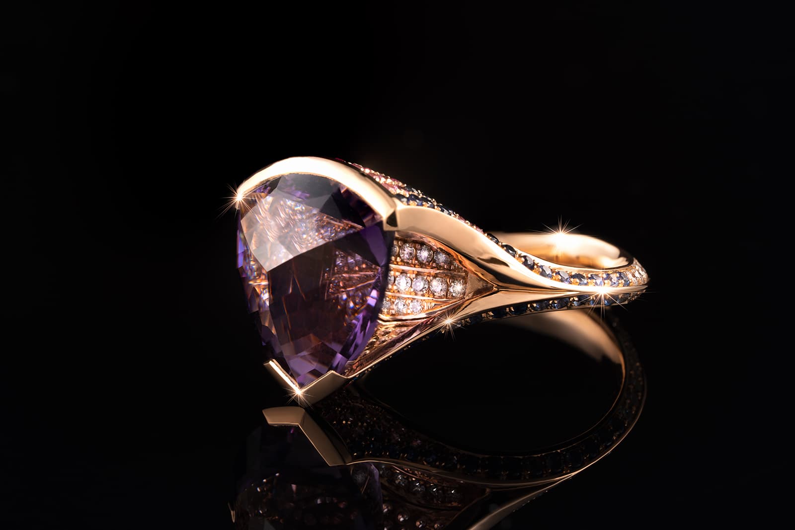  Nigel O’Reilly Opicie Scapolite ring with a 5.9ct trillion-cut scapolite set in 18k rose gold, alongside blue and pink sapphires, rubies and diamonds 