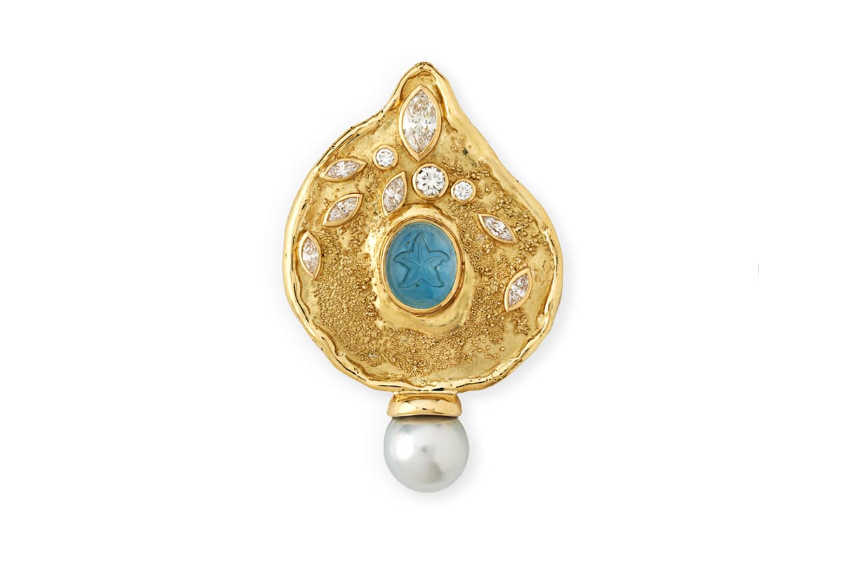  Elizabeth Gage 18k yellow gold Shiraz pin set with an oval cabochon aquamarine intaglio engraved with a starfish design, alongside marquise-cut diamonds 