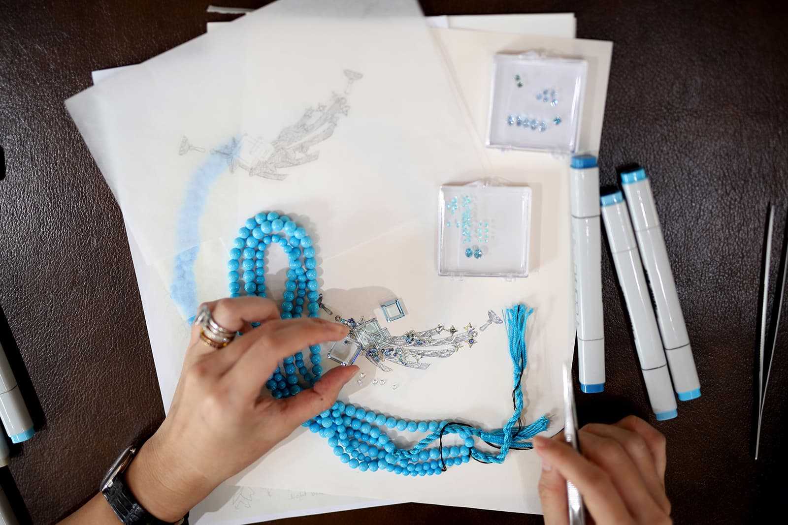  Calla Lily Founder, Emily Tan, designing the Constellation necklace with a detachable brooch inspired by the customer's turquoise beads