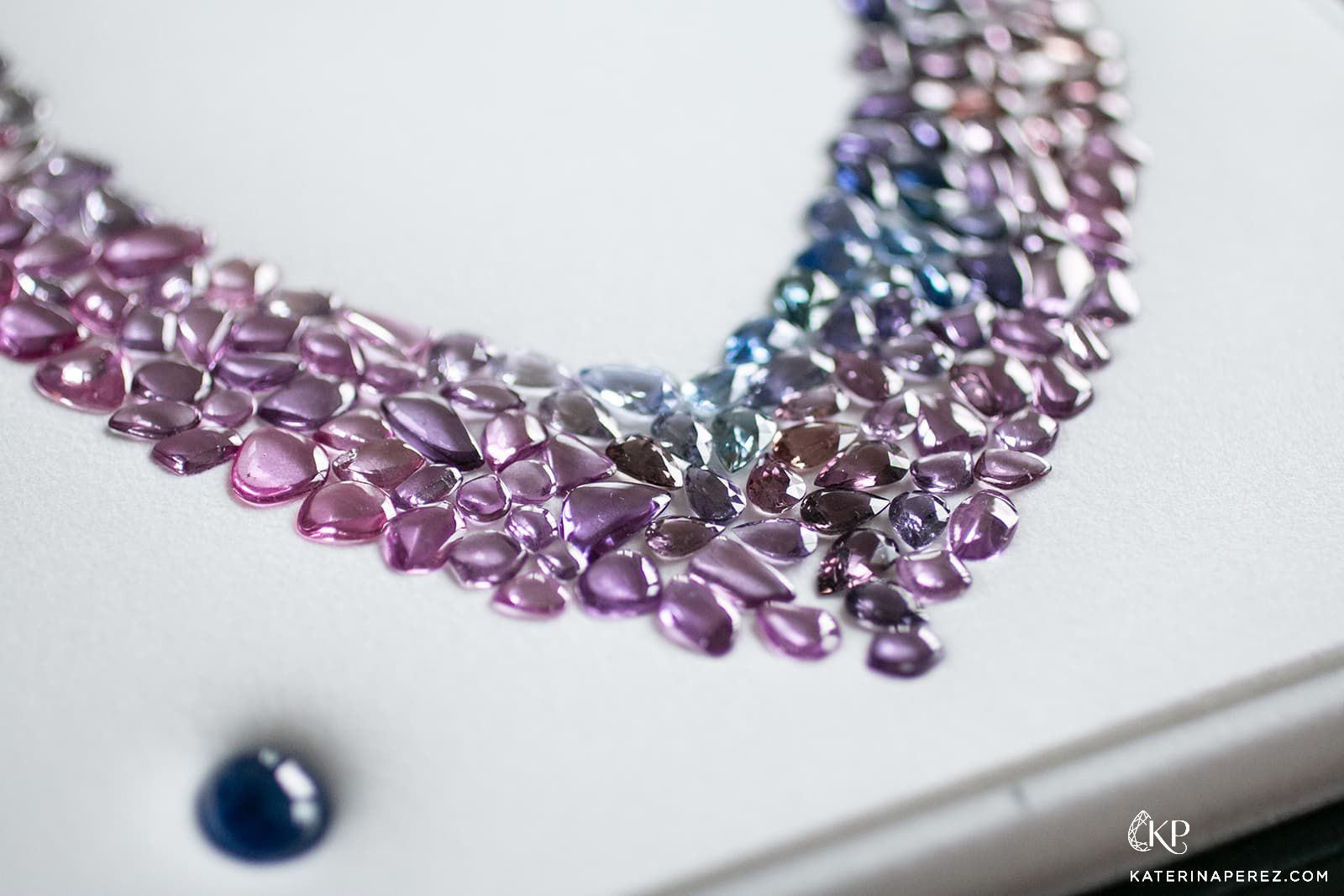 A multi-coloured sapphire cabochon necklace layout by Paul Wild 