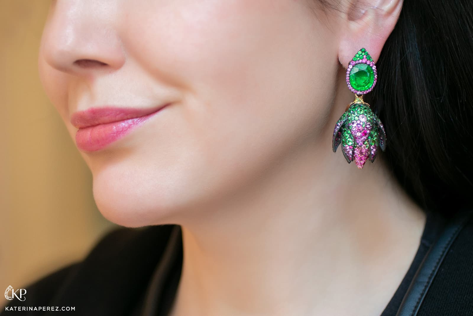 Katerina Perez wears a pair of floral drop earrings by Antonio Seijo in shades of vibrant pink and green