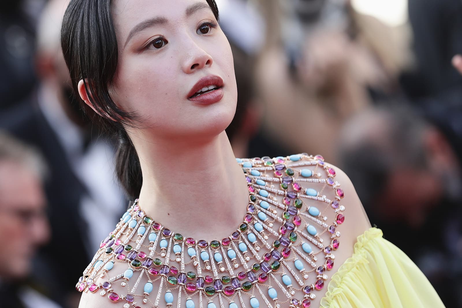 Chinese actress Li Meng at the Cannes Film Festival wearing a Bulgari High Jewellery poncho necklace with amethyst beads, cabochon rubellites, tourmalines, turquoise beads and round brilliant-cut diamonds 