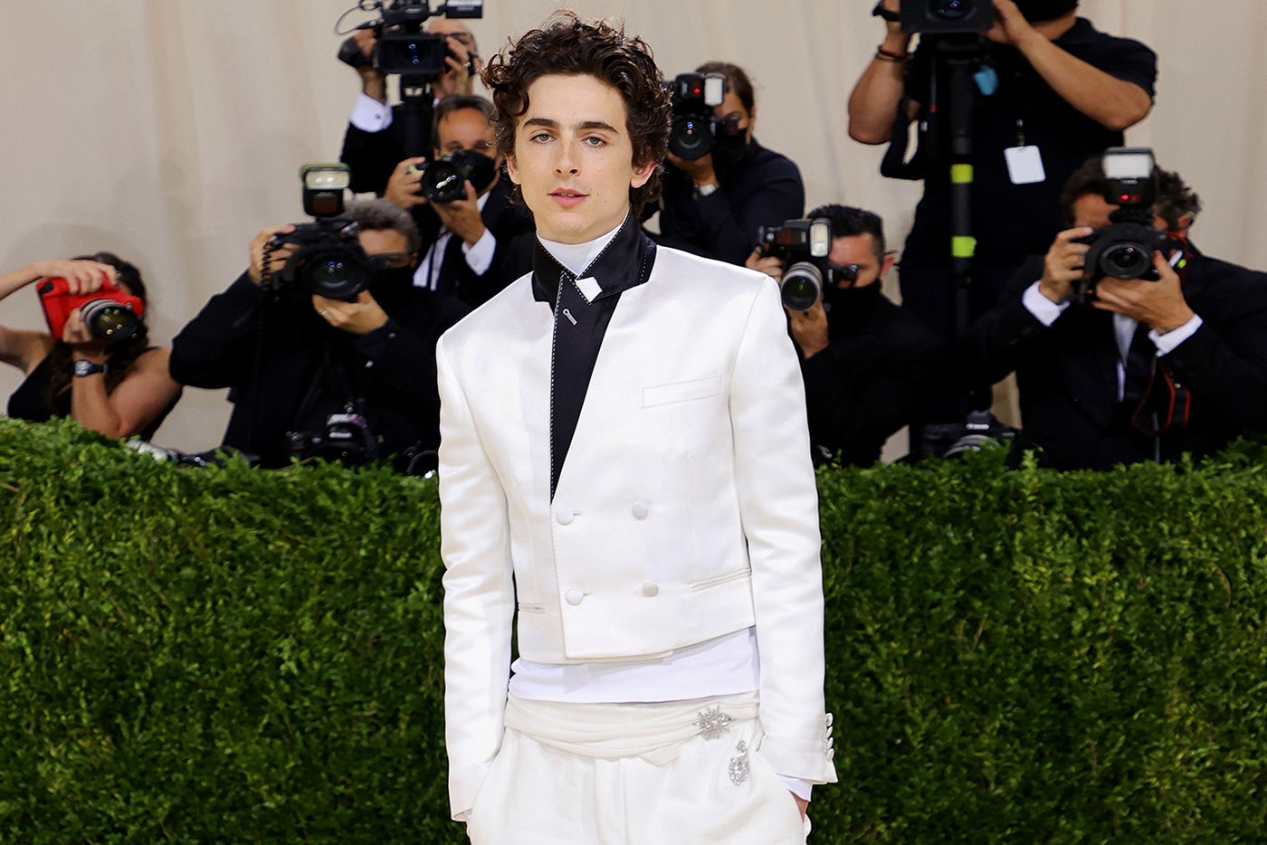  Actor Timothée Chalamet at the Met Gala 2021 wearing diamond brooches by Cartier