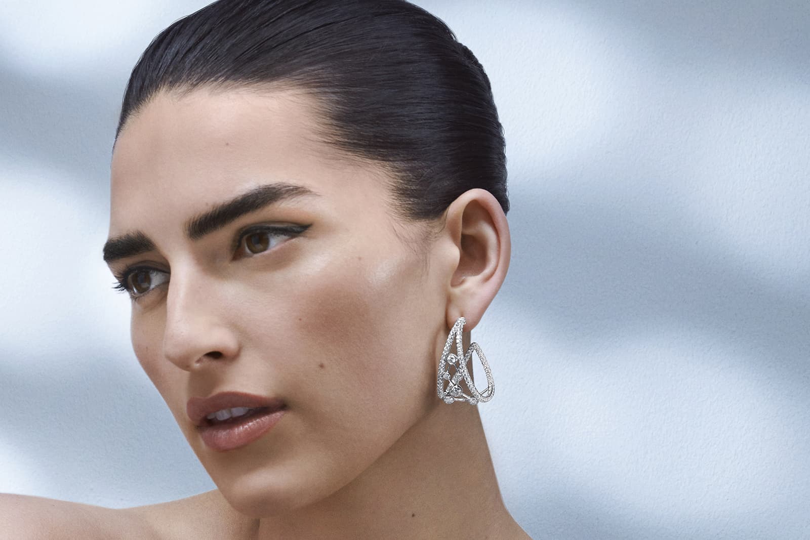  De Beers Jewellers The Alchemist of Light High Jewellery Atomique hoop earrings inspired by a diamond’s crystalline patterning