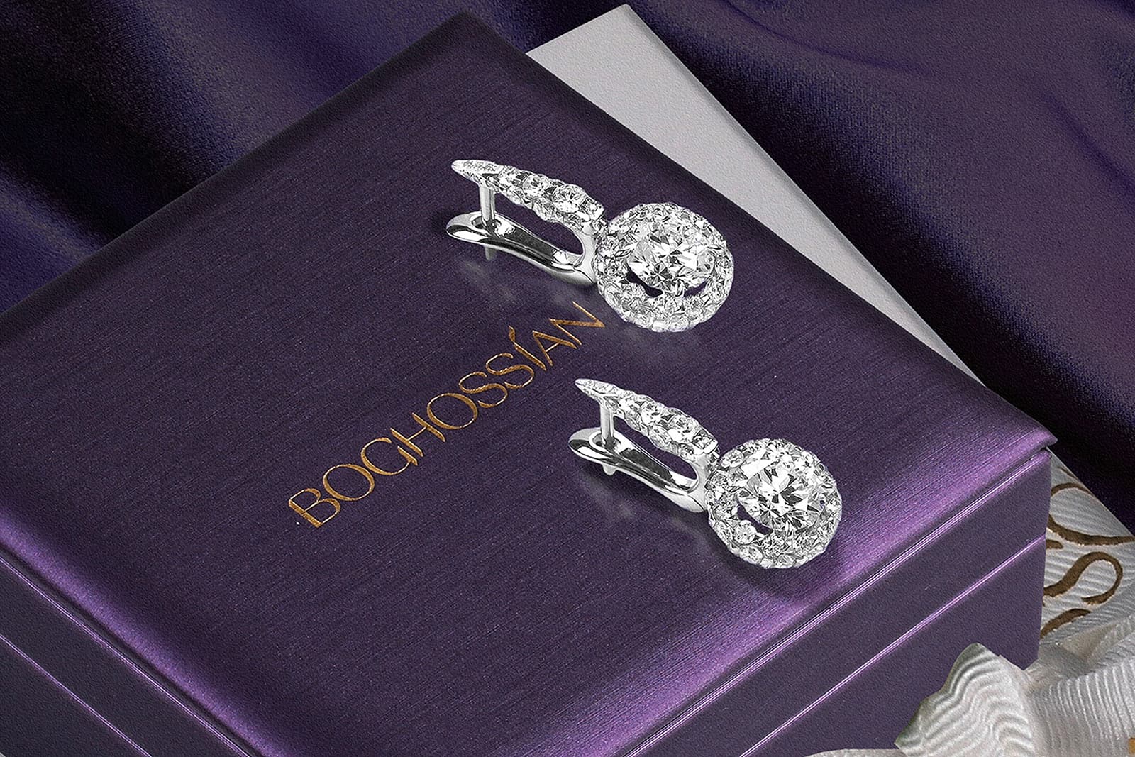  Diamond earrings on top of a purple Boghossian box