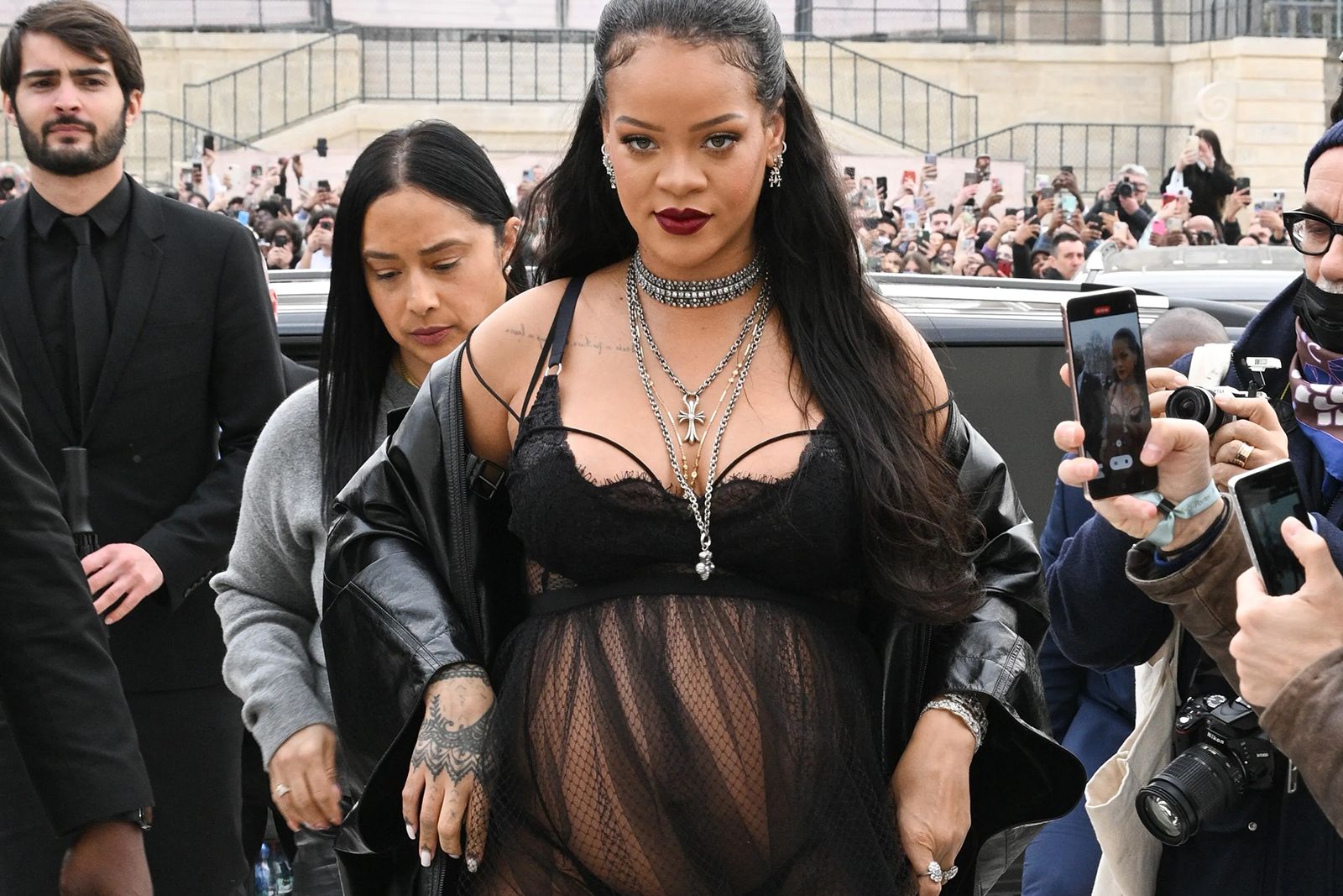 Rihanna wearing the 'neck mess' trend at the Dior Fall/Winter 2022/2023 show at Paris Fashion Week