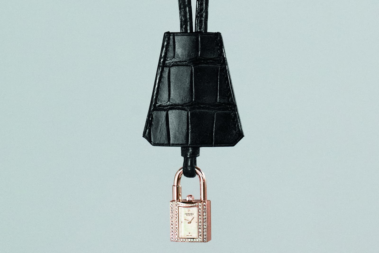  The New Kelly watch by Hermès in rose gold and diamonds, set on a black alligator leather strap