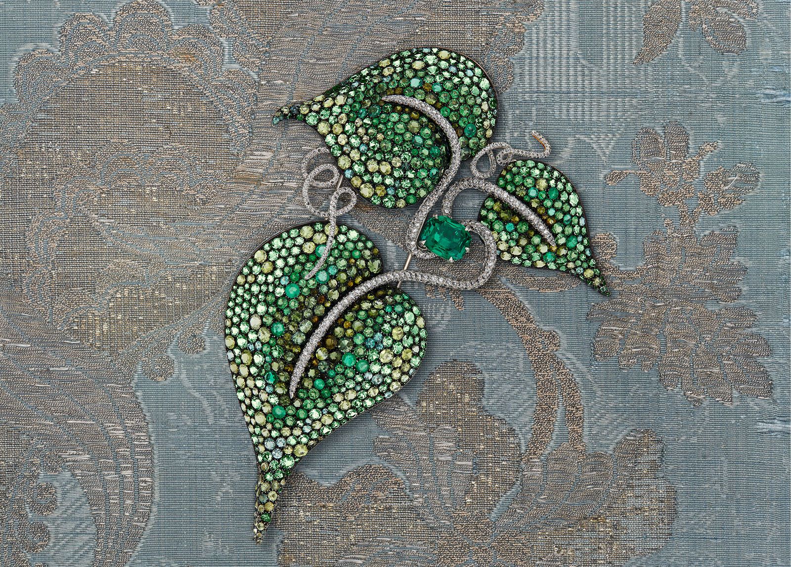 JAR multi-gemstone and diamond Leaf brooch with a cushion-cut emerald of 11.96 carats, further emeralds, beryls, peridots, garnets, green tourmalines and diamonds in 14k and 18k yellow gold, platinum and silver (1989)