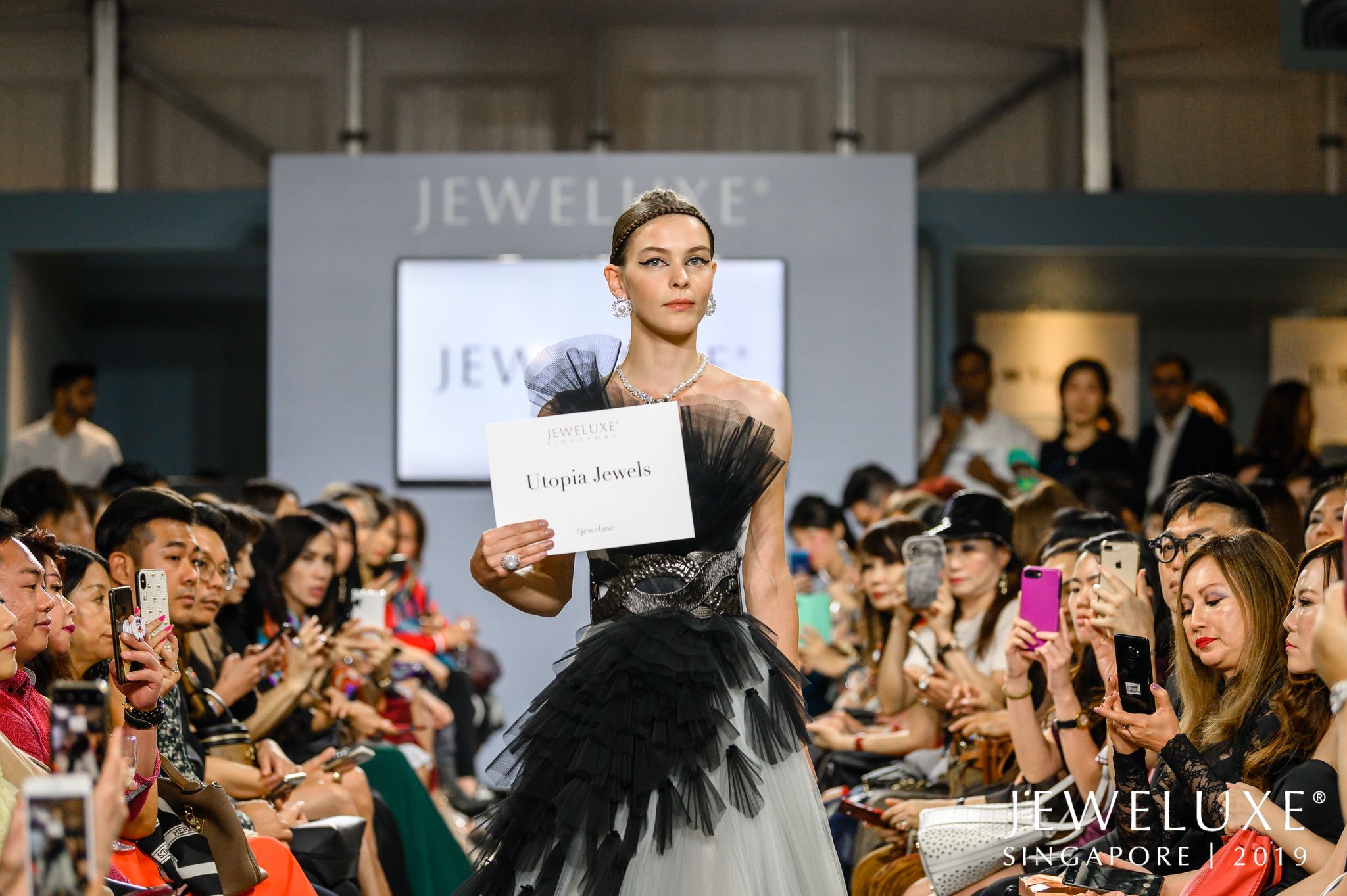 A model wears Utopia Jewels on the runway at the JeweLuxe fashion show