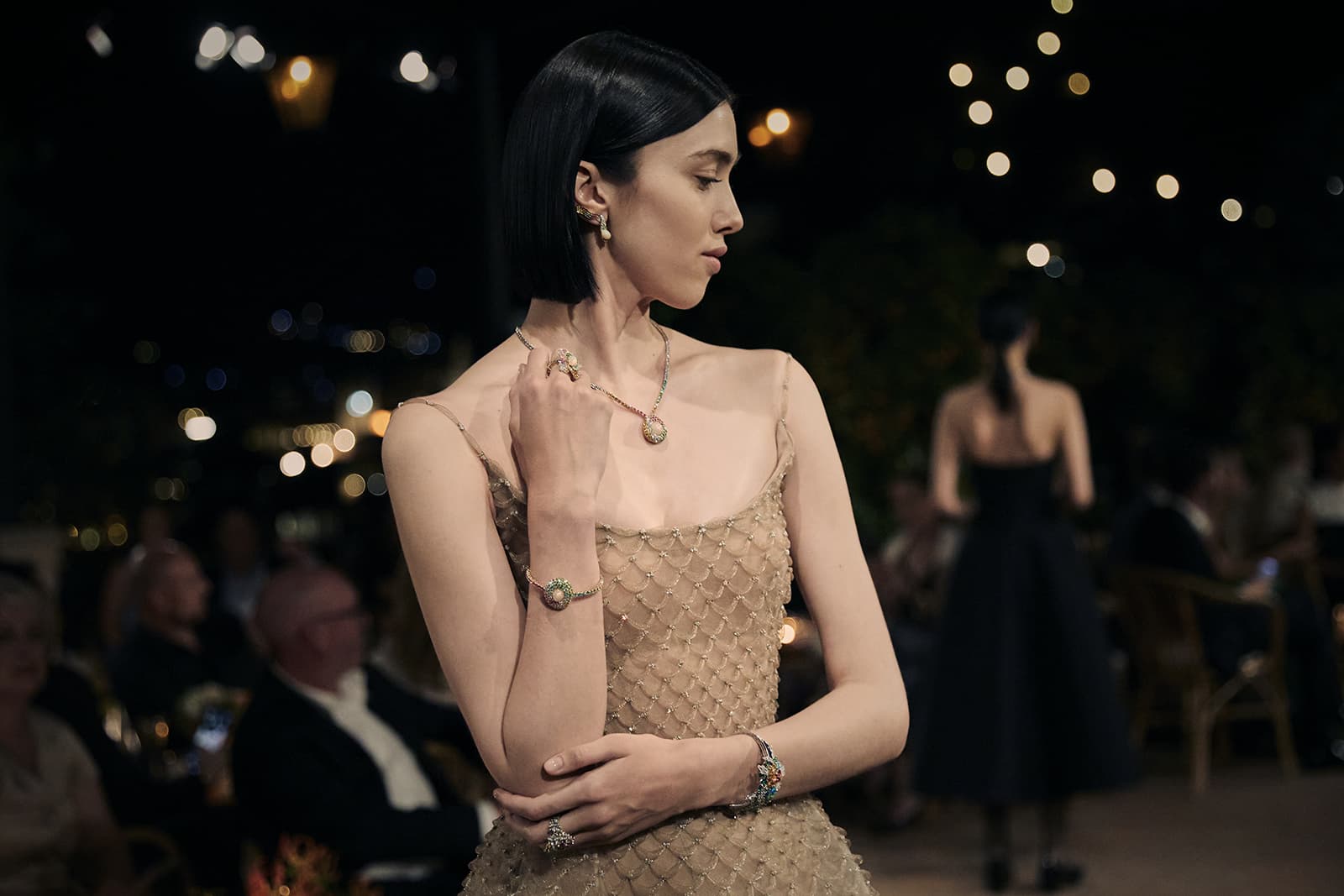 A model wears opal cabochon and multi-coloured gemstone jewellery pieces from the Dior Print High Jewellery collection