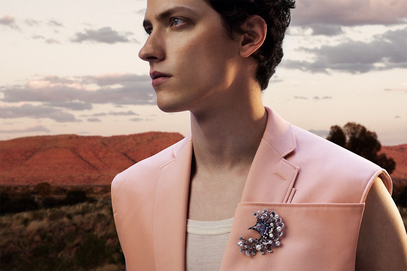 A model wears the Mikimoto Australia Victoria Crowned Pigeon brooch in 18k white gold with Akoya cultured pearls, sapphire, ruby, alexandrite, spinel, tourmaline and diamonds from the Wild and Wonderful High Jewellery collection