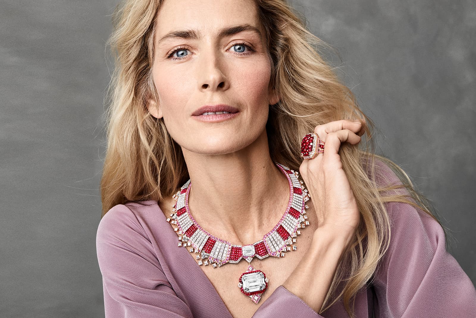 Model wearing Van Cleef & Arpels gold, ruby and diamond Collerette Mysterieuse transformation High Jewellery necklace from the Legend of Diamonds Chapter I Collection 