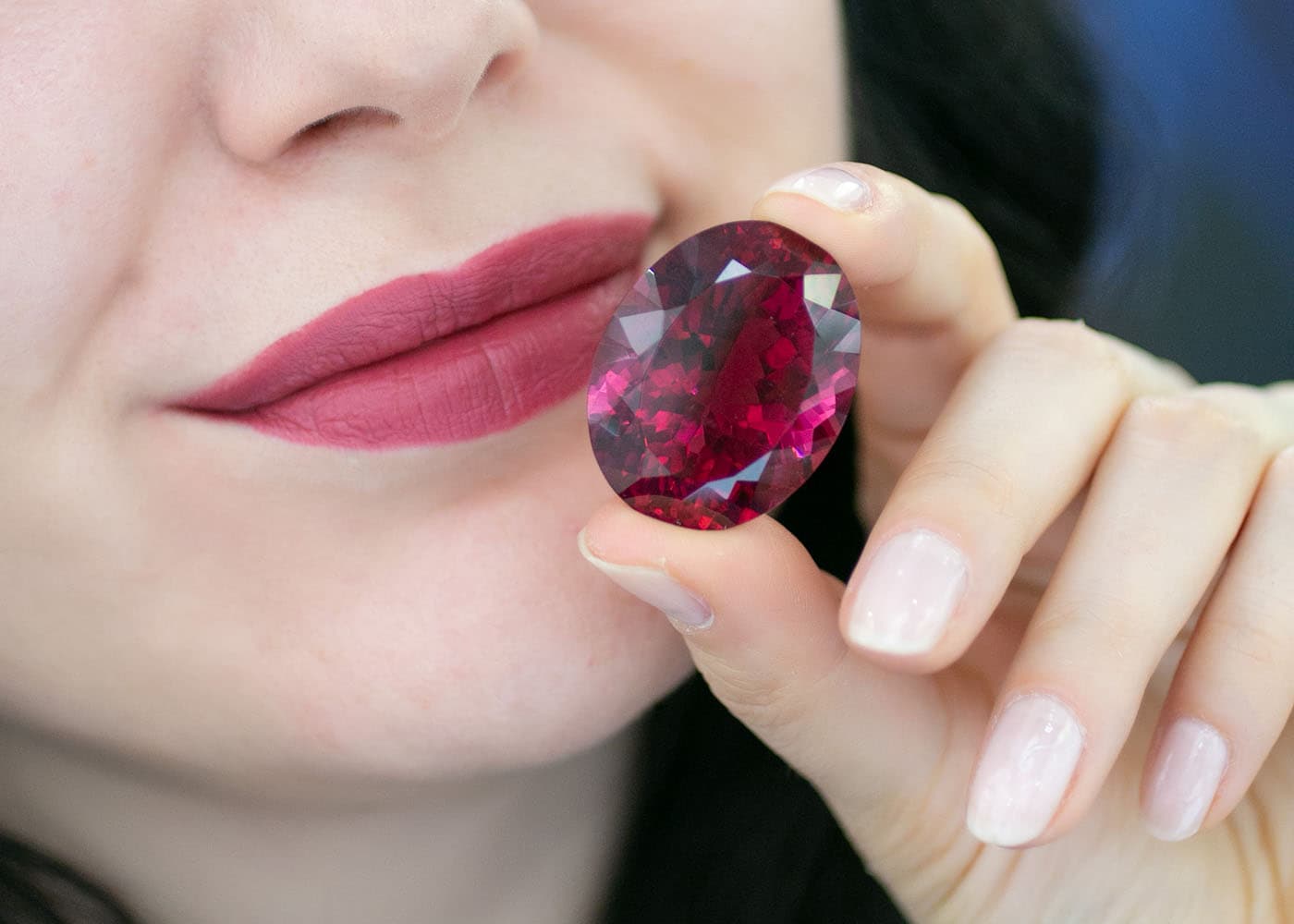 Katerina Perez holding an oval rubellite from the Nicole Ripp Collection