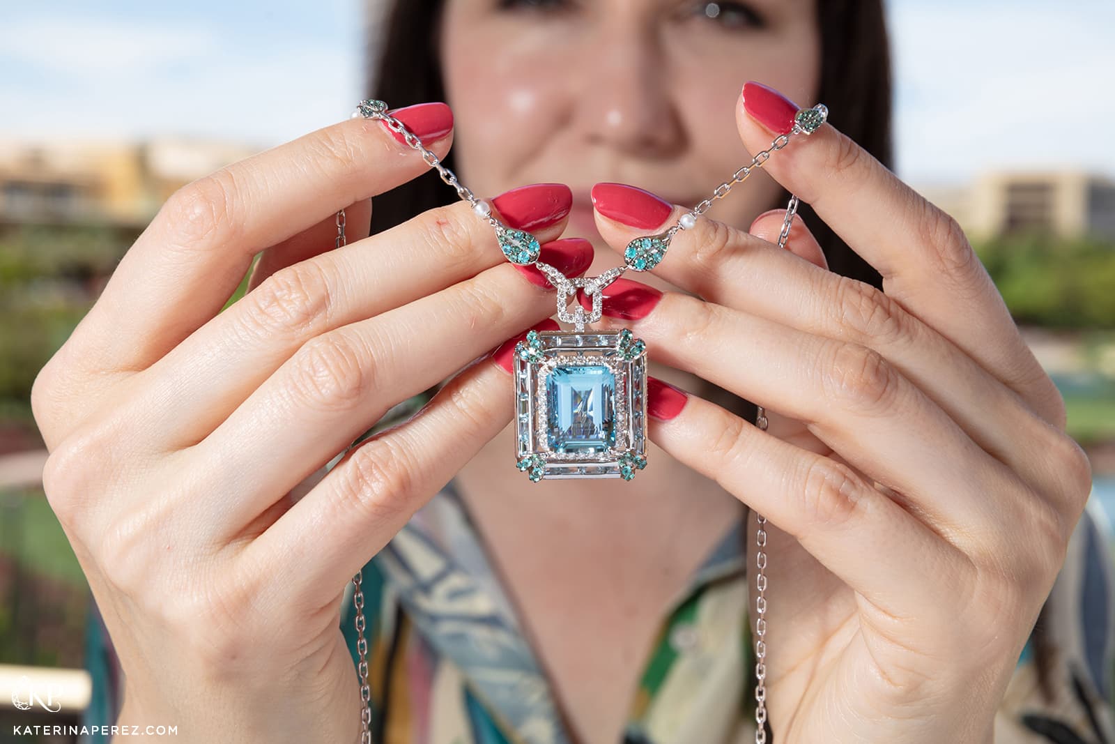 Katerina Perez holds the Sunita Nahata Blue Lagoon aquamarine pendant from the Blue Planet II collection