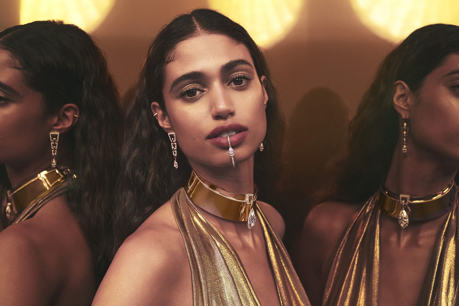 Model wearing Messika gold and diamond Golden Shield earrings, lip jewel and choker from the Beyond the Light High Jewellery collection