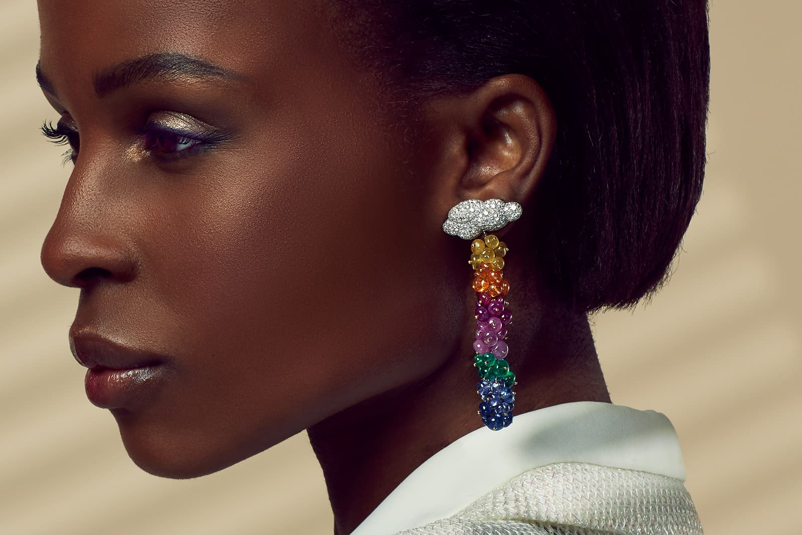 K&Co Iridiana earrings with clusters of emeralds, tanzanites, pink and yellow sapphires, and orange spessartine garnets and diamond-set white gold clouds 