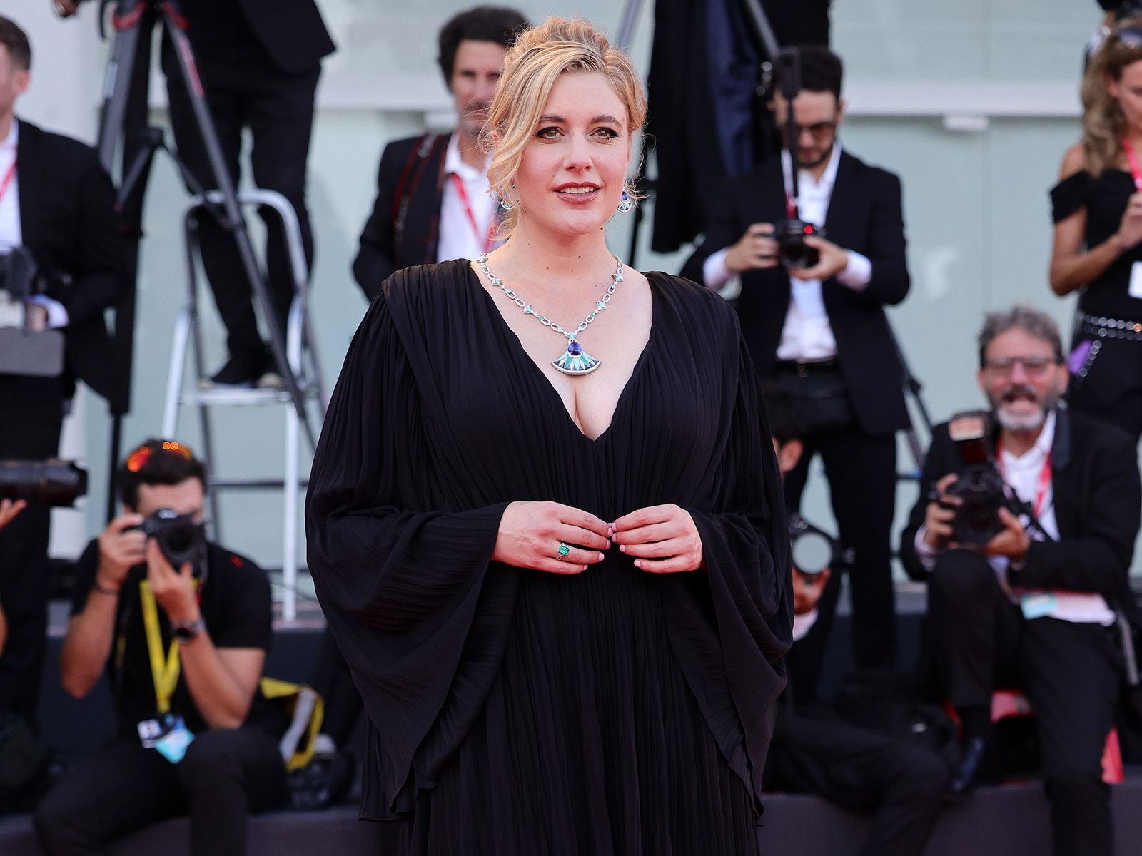 Actress and director Greta Gerwig wears a Bulgari Diva’s Dream High Jewellery set with mother of pearl, turquoise, chrysoprase and a 27.77 carat tanzanite at the 2022 Venice International Film Festival 