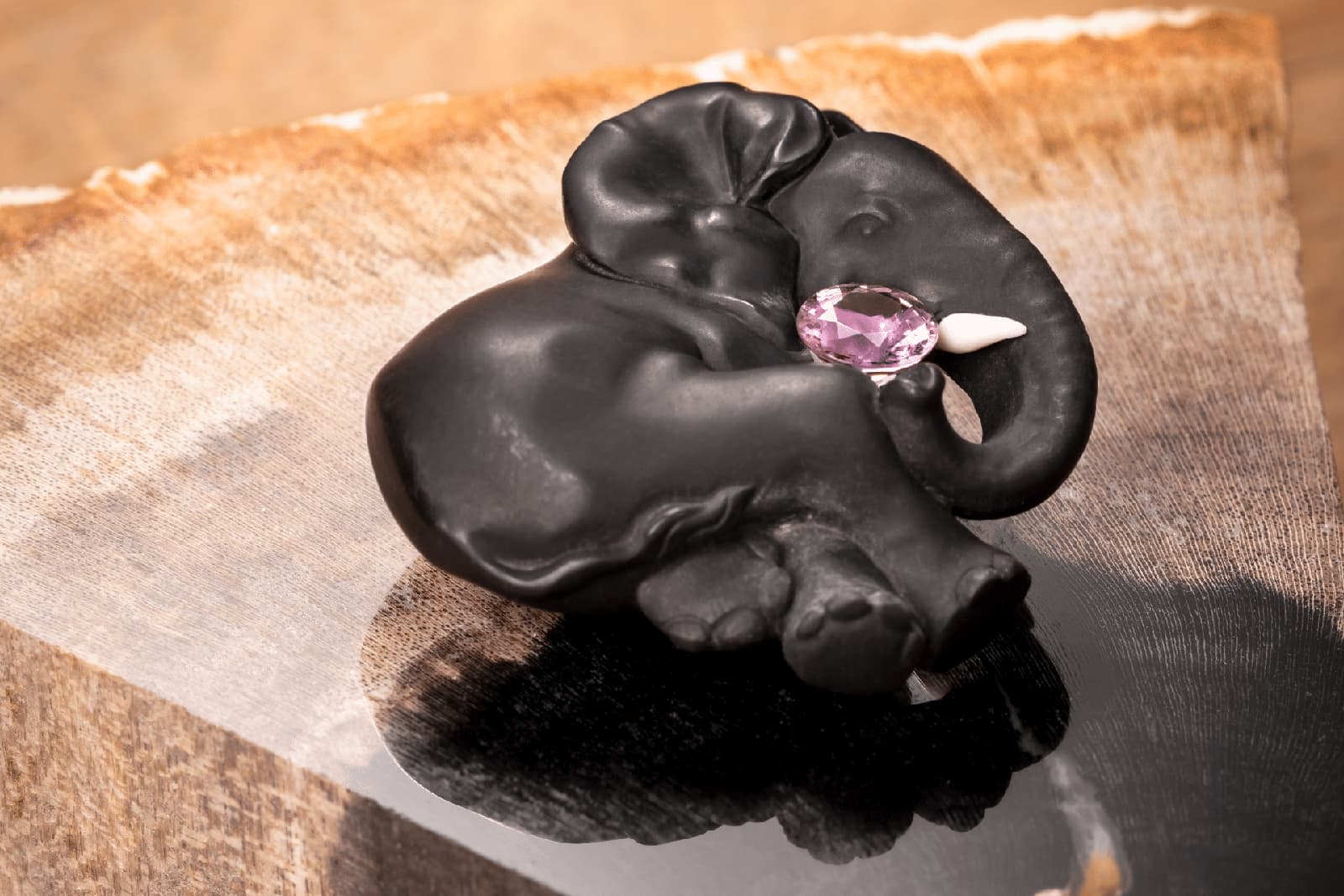  The Cartier Éléphant Noir brooch in crafted in petrified magnolia wood with a pink sapphire