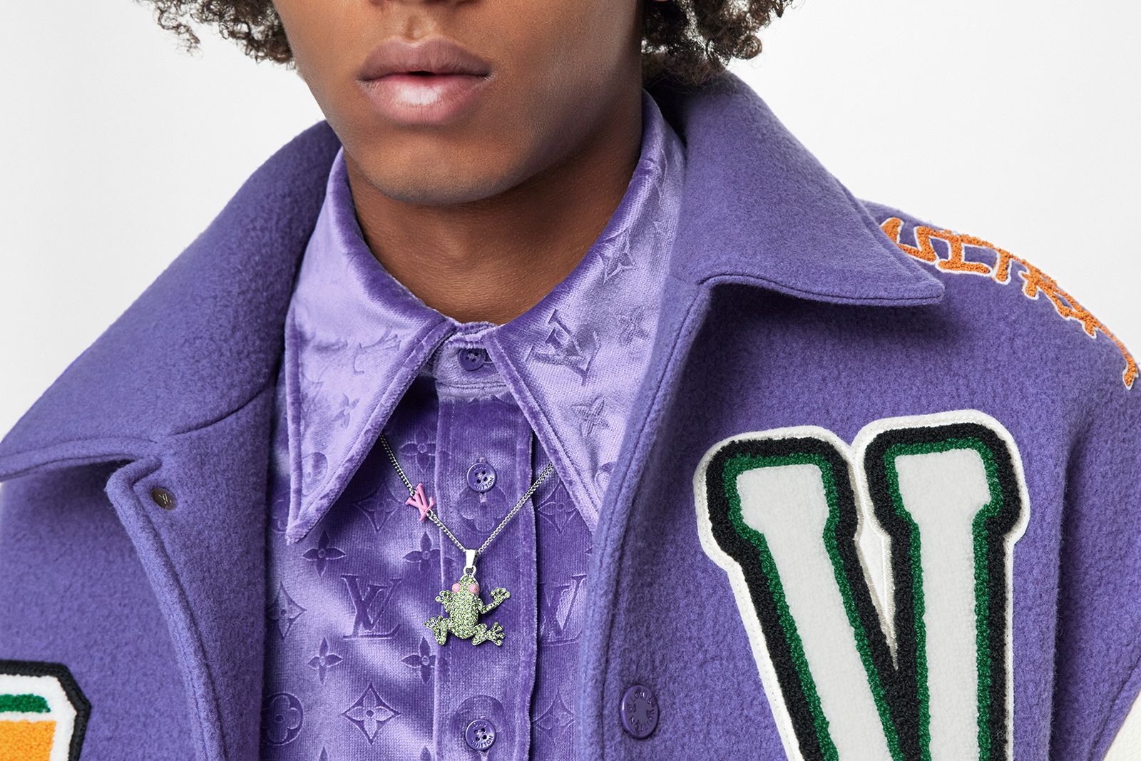 Male model wearing Louis Vuitton Crazy Animals necklace in green and pink enamel
