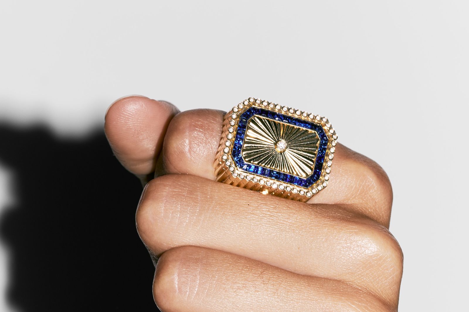Model wearing Marie Lichtenberg Dick in a box ring in gold, sapphires and diamonds