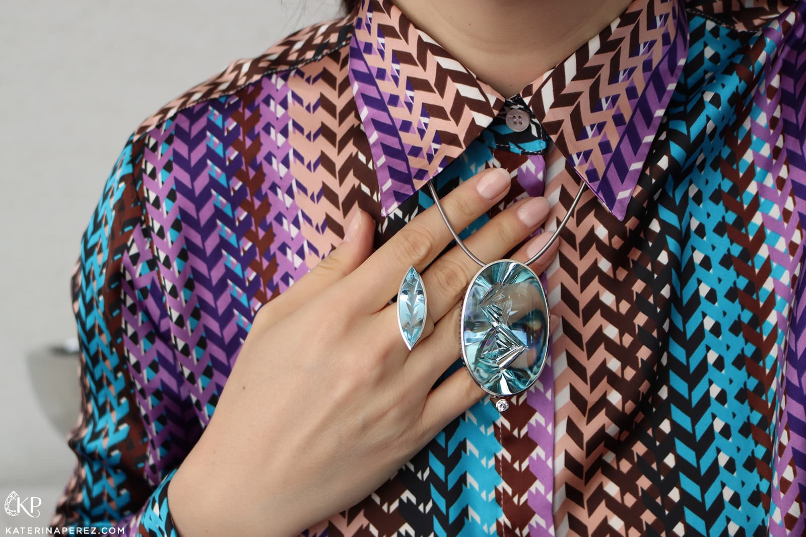 Katerina Perez wearing the Atelier Munsteiner Maverick necklace featuring a 172.73 carat aquamarine alongside the Maverick ring with a 9.47 carat aquamarine 
