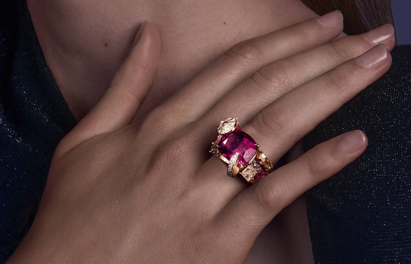 Model wearing Piaget Lady Pink transformable ring in rose gold, a 9.99 cushion-cut  rubellite, sapphire, spinel, spessartite, citrine and diamond, from the Solstice by Piaget High Jewellery Collection, Chapter Two