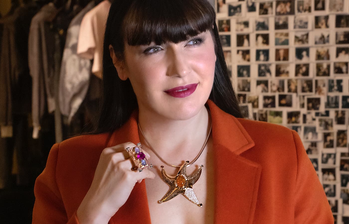 Katerina Perez wears a Starfish pendant with fire opal, diamonds and rubies and a ring with pink tourmaline, star sapphire and tanzanite by Nathalie Knauf Jewels 