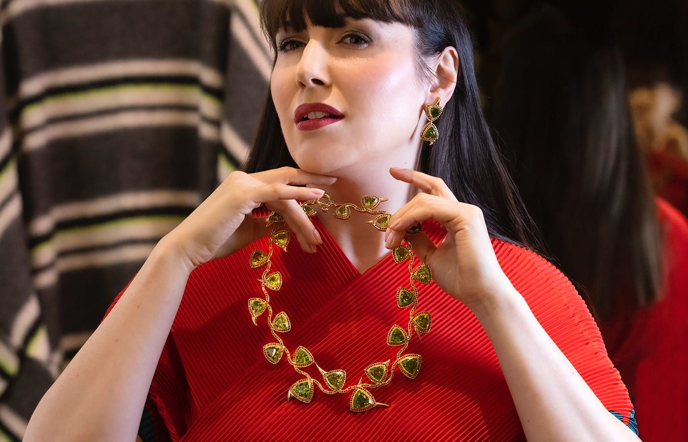 Katerina Perez showcases the Thorns necklace and matching earrings by Nathalie Knauf Jewels with trillion-cut peridot gemstones 