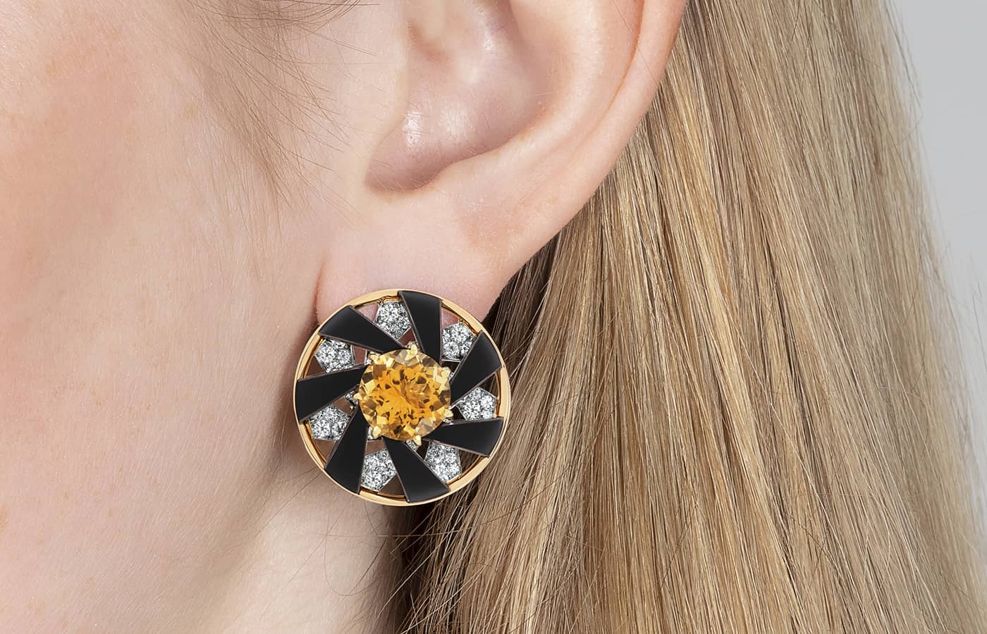 Model wearing Lily Gabriella Supernova earrings in rose gold, yellow gold, platinum, enamel, citrine and diamond