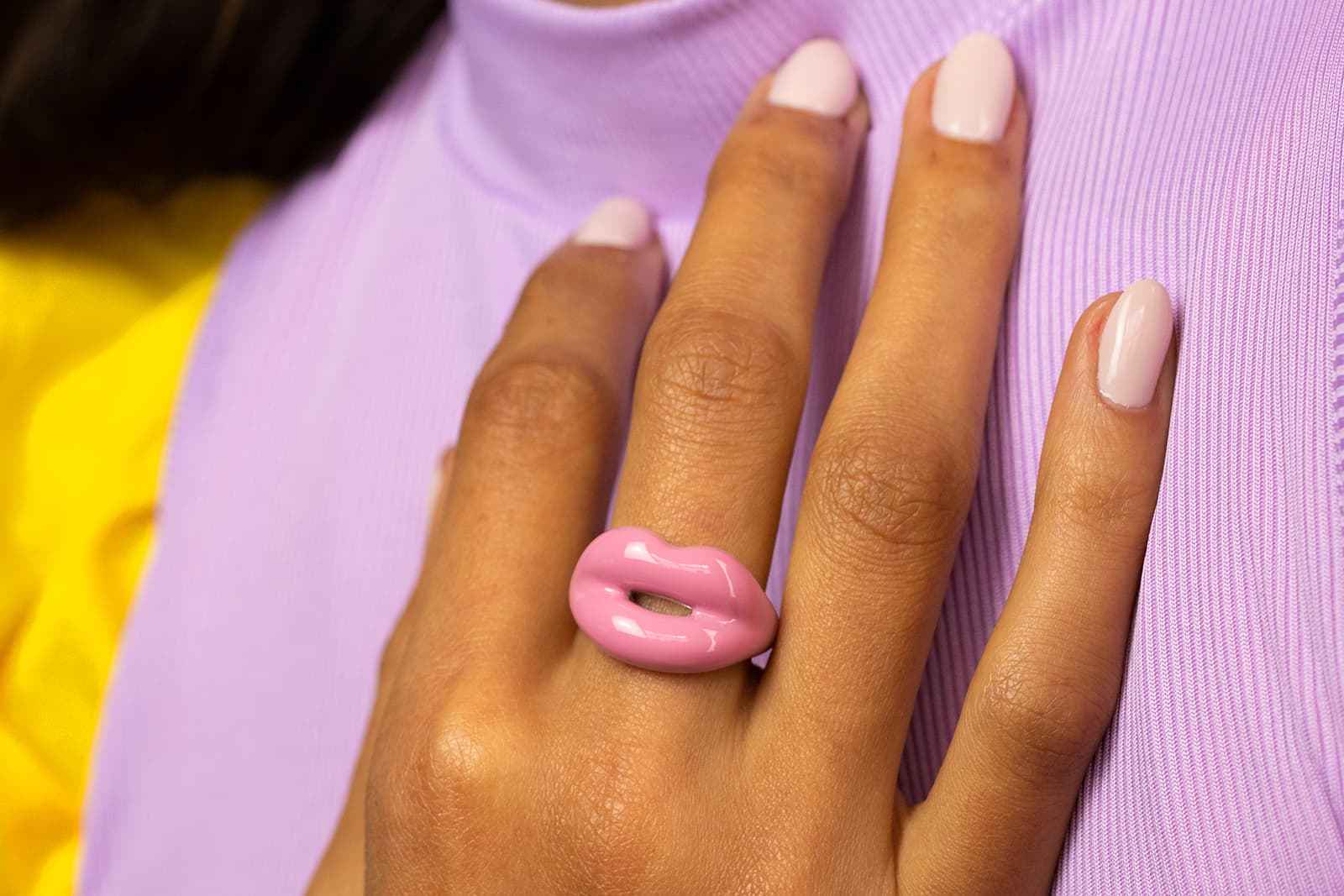  Model wearing the Bubblegum Pink Hotlips ring created in hand painted enamel and 100% recycled sterling silver by Solange Azagury-Partridge
