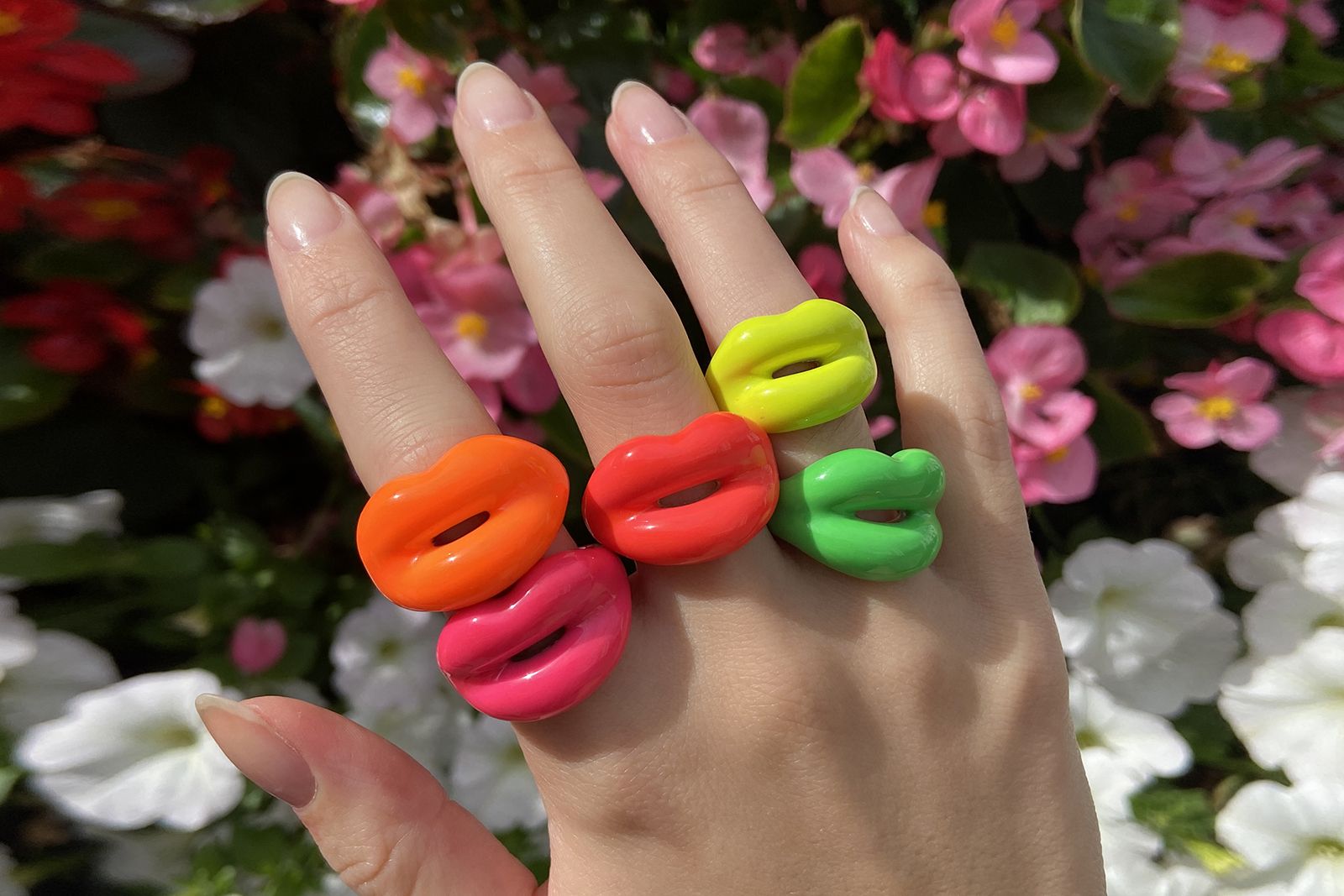 Model wearing the Neon Hotlips ring colour ways created in hand painted enamel and 100% recycled sterling silver by Solange Azagury-Partridge
