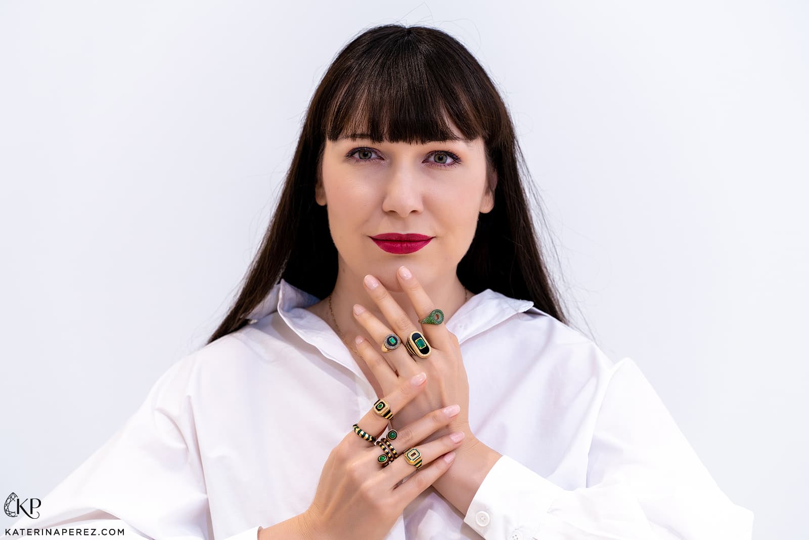 Katerina Perez wears yellow gold, black onyx, enamel and emerald rings by State Property