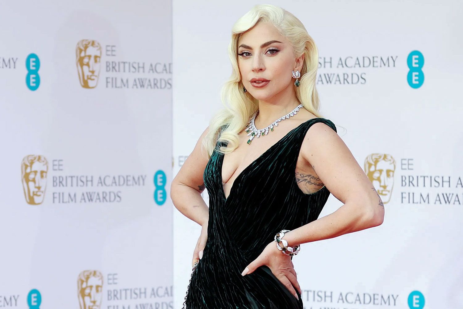  Lady Gaga wearing a Tiffany & Co. emerald and diamond suite to the BAFTAs in April 2022