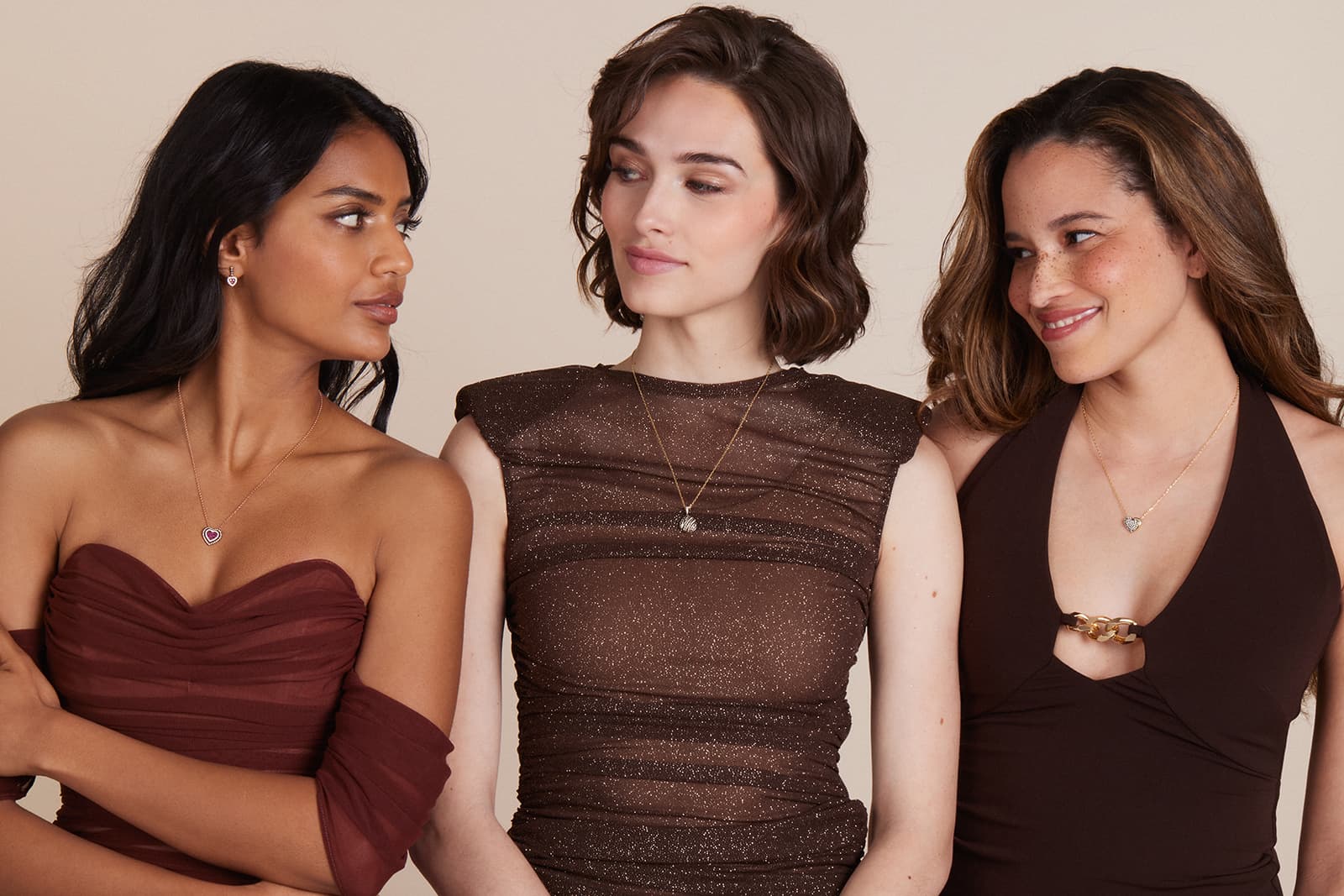 Models wearing GODIVA x Le Vian heart-shaped jewellery featuring enamel, rubies, diamonds and Chocolate diamonds