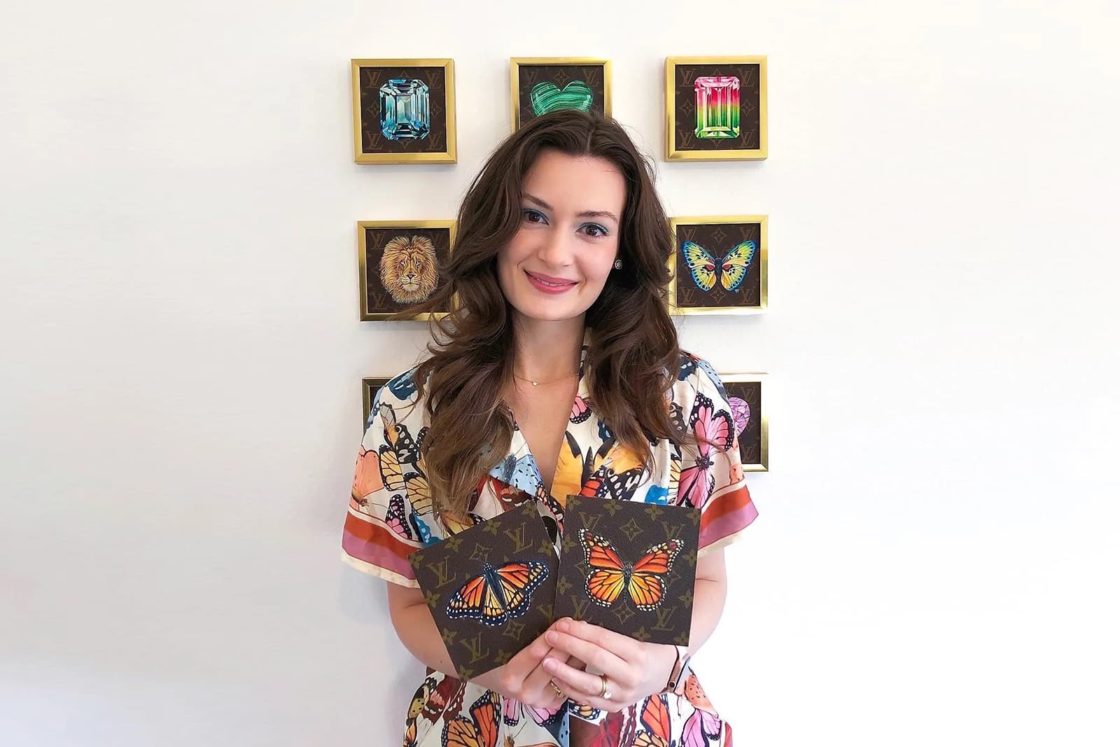 Artist Hadden Sharapov holding her hand-painted creations 