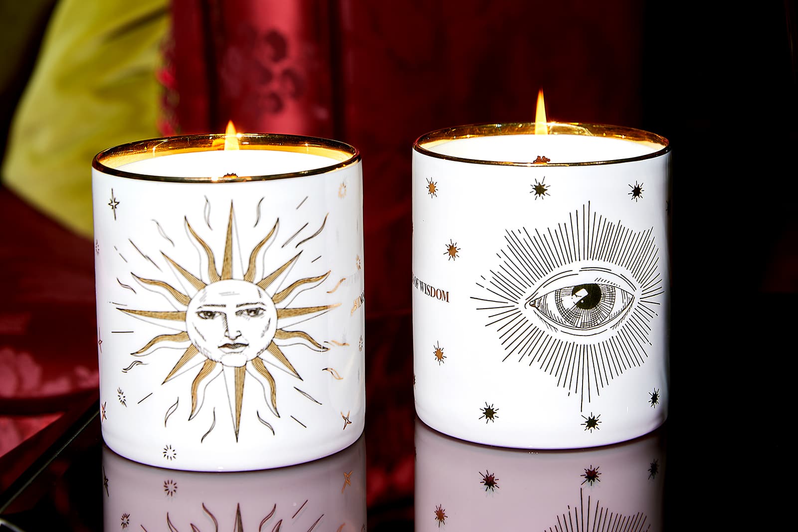 Close up of candles by Wings of Wisdom set in bone china and gold vessels