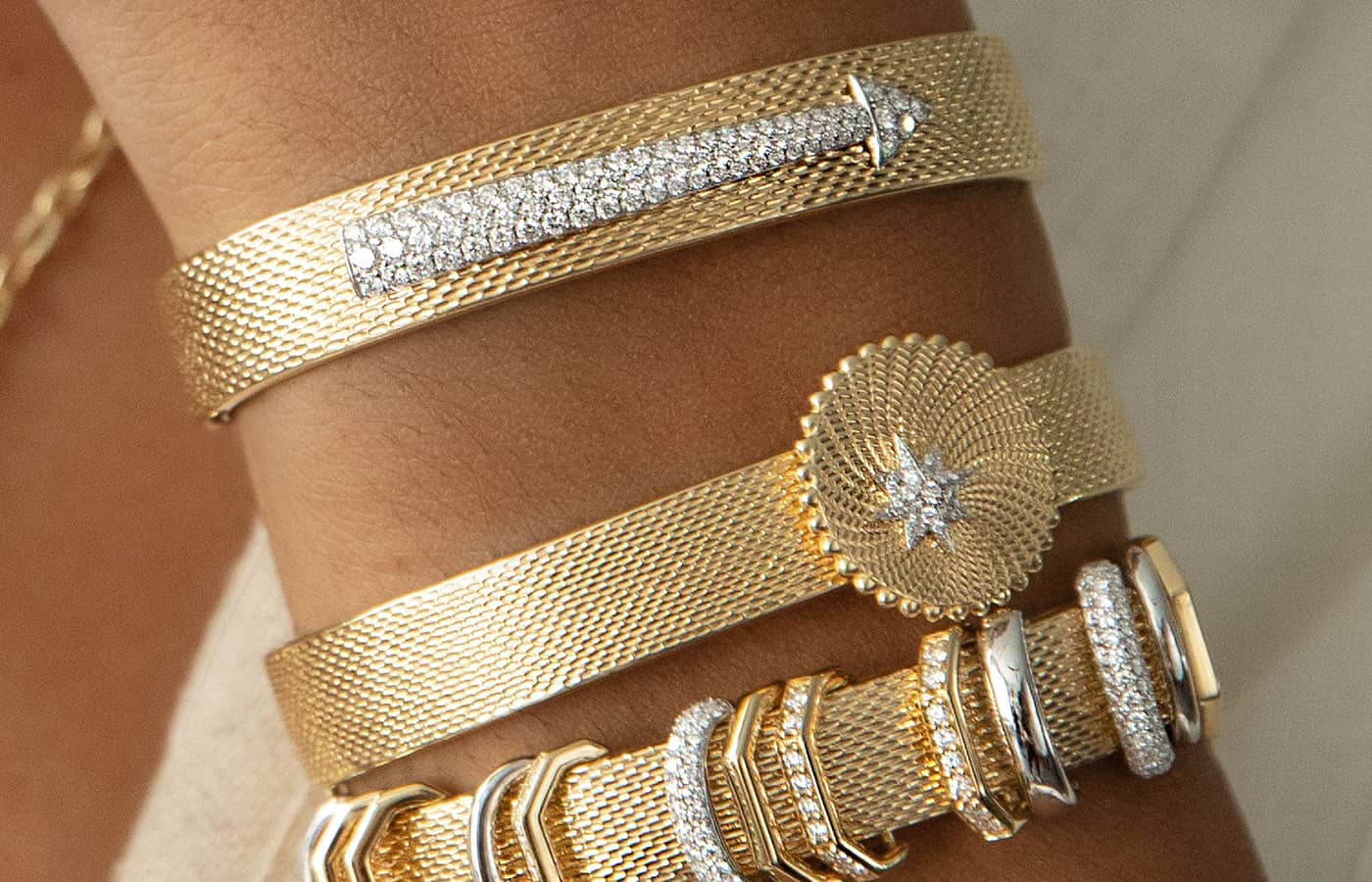  Model wearing AWKN1 yellow gold and diamond bracelets 