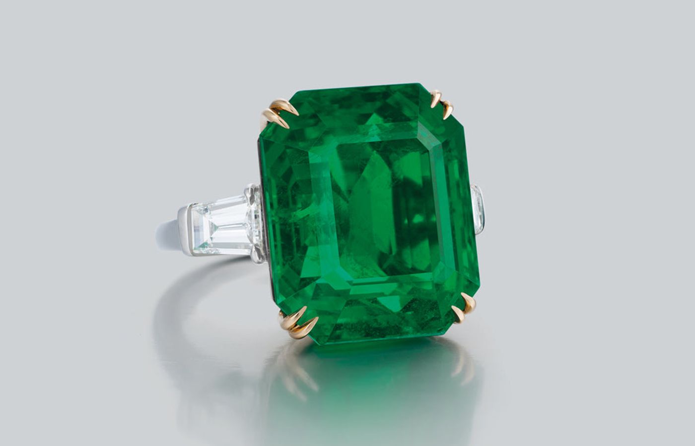  Ronald Abram ring featuring a 23.31-ct emerald cut old mine Colombian emerald with tapered baguette diamonds