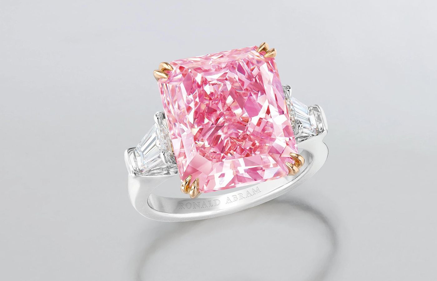 Ronald Abram ring featuring a 10.24-ct radiant cut fancy intense purplish-pink diamond with tapered baguette diamonds
