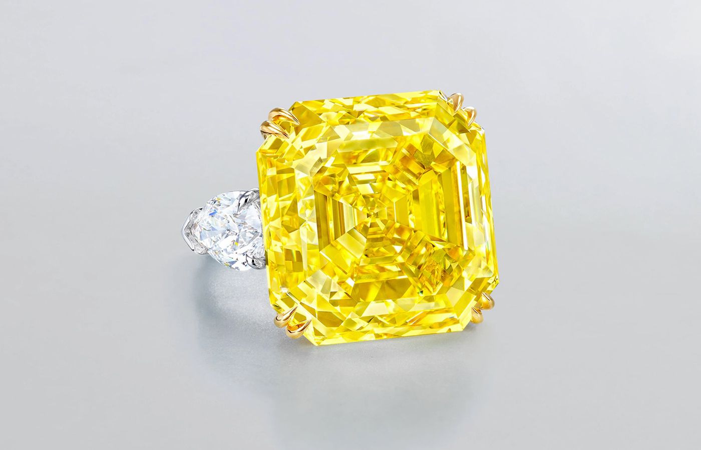  Ronald Abram ring featuring a 42.88-ct asscher cut fancy intense yellow diamond with pear shape diamonds