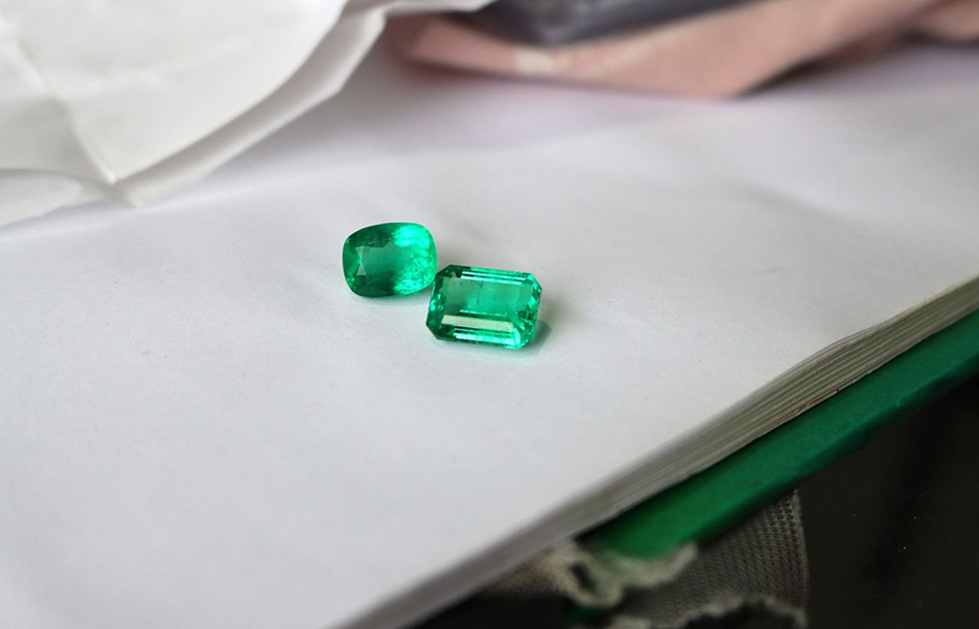 A cushion- and emerald-cut emerald photographed at the International Emerald Exchange (IEEX) in Bogota, Colombia in April 2022