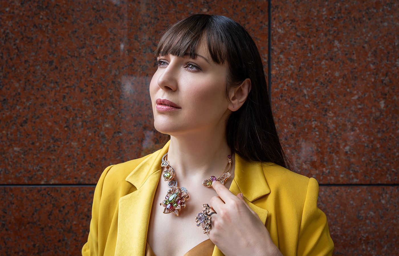 Katerina Perez wears a necklace and ring by Caratell 