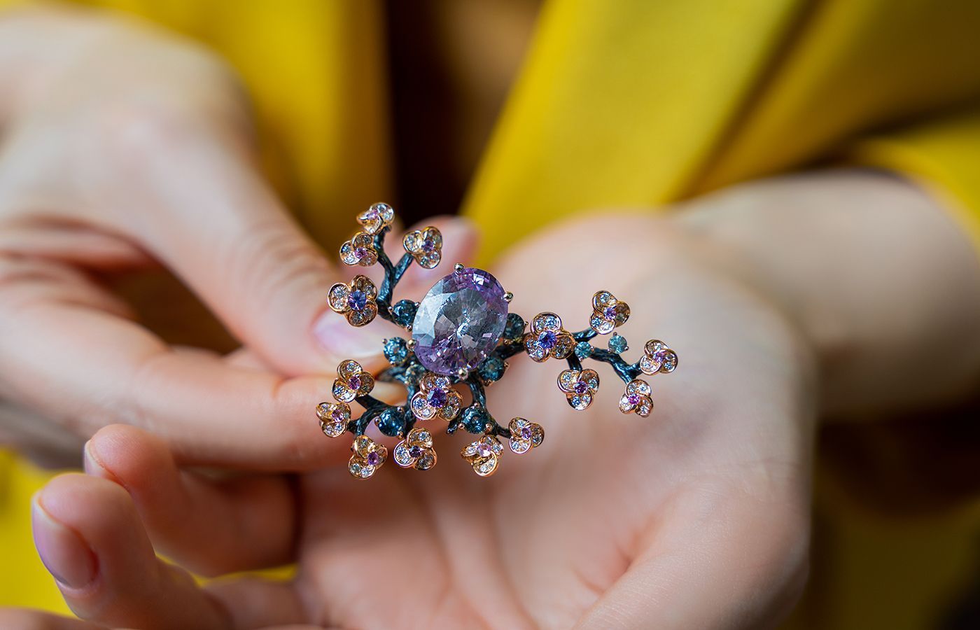 Caratell Plum Blossom ring with an oval-shaped purplish-pink sapphire centre stone