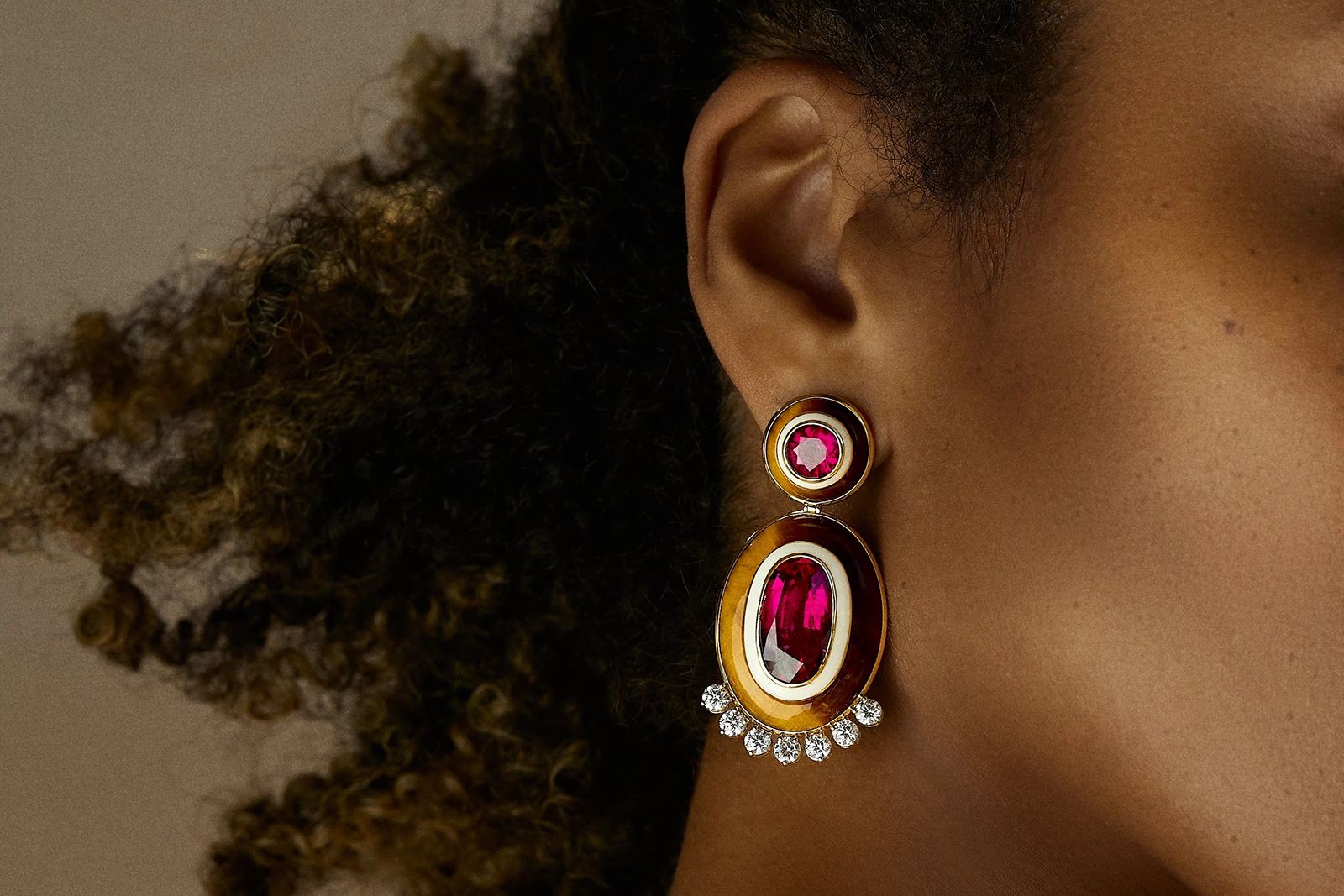 Model wearing Emily P. Wheeler Diana earrings in white enamel, tiger's eye and pink rubellite