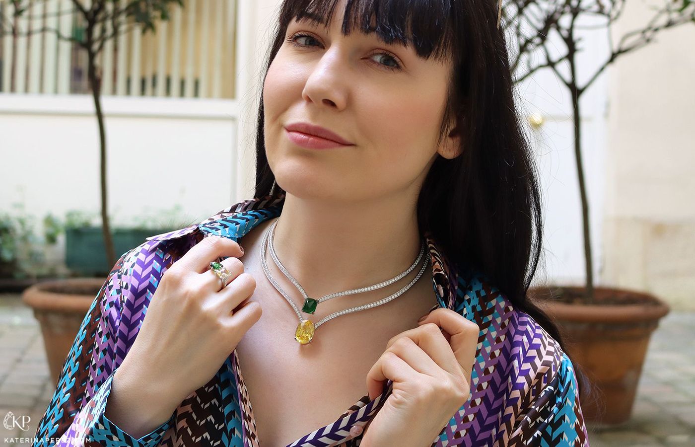  Katerina Perez wears necklaces by Maison Avani set with a yellow sapphire and tsavorite garnet